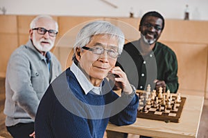 Senior friends playing chess
