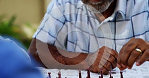 Senior friends playing chess 4k