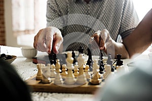 Senior friends playing chess together