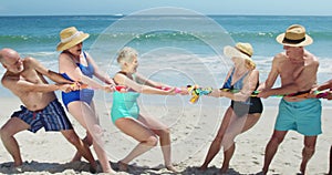 Senior friends playing tug of war