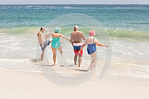 Senior friends playing in water