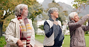 Senior friends, talking and walking together on an outdoor path to relax in nature with elderly women in retirement