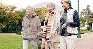 Senior friends, talking and walking together on an outdoor path to relax in nature with elderly women in retirement