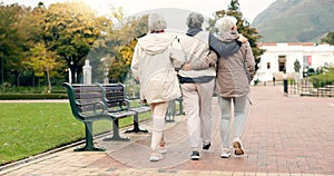 Senior friends, talking and walking together on an outdoor path to relax in nature with elderly women in retirement