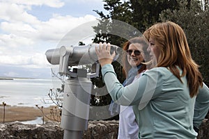 senior friends tourists outdoor adventure together on mediterranian sea