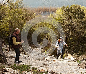 senior friends tourists outdoor adventure together on mediterranian sea