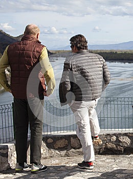 senior friends tourists outdoor adventure together on mediterranian sea