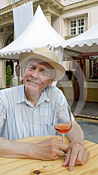 Senior with glass of rose wine