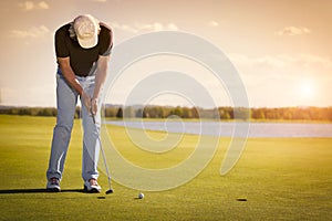 Senior golf player on green with copyspace.