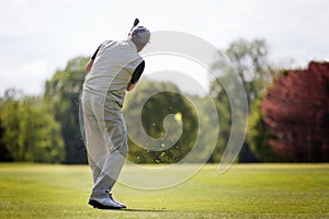 Senior golfer on fairway. photo