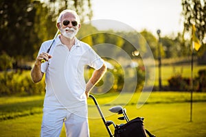 Senior golfer standing on court