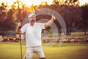 Senior golfer with thumb up