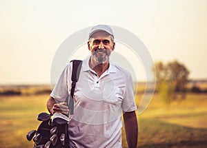 Senior golfer walking on golf court with bag