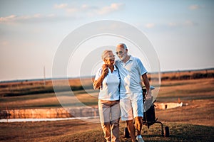 Golfers talking and walking on golf course