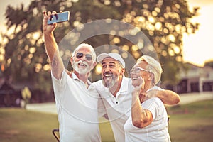 Senior golfers using phone and taking self portrait
