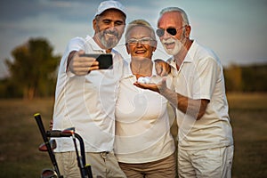 Golfers using phone and taking self portrait