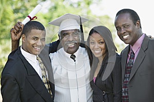 Senior graduate with son and grandchildren outside portrait