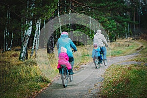 Senior grandparents with kids riding bikes in nature