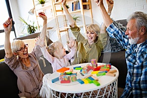 Senior grandparents playing with grandchildren and having fun with family