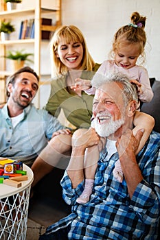 Senior grandparents playing with grandchildren and having fun with family