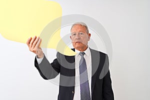 Senior grey-haired businessman holding speech bubble over isolated white background with a confident expression on smart face