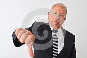 Senior grey-haired businessman wearing suit standing over isolated white background looking unhappy and angry showing rejection