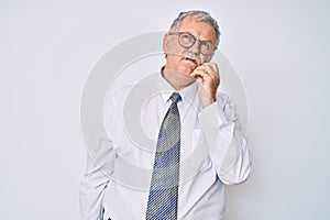 Senior grey-haired man wearing business clothes serious face thinking about question with hand on chin, thoughtful about confusing