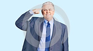 Senior grey-haired man wearing business jacket smiling pointing to head with one finger, great idea or thought, good memory