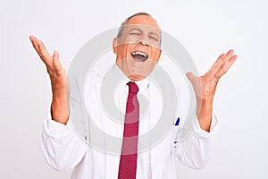 Senior grey-haired scientist man wearing coat standing over isolated white background celebrating mad and crazy for success with