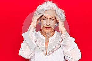 Senior grey-haired woman wearing casual clothes with hand on head, headache because stress