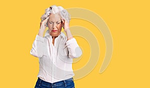 Senior grey-haired woman wearing casual clothes with hand on head for pain in head because stress