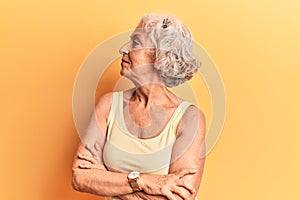 Senior grey-haired woman wearing casual clothes looking to the side with arms crossed convinced and confident