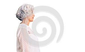 Senior grey-haired woman wearing casual clothes looking to side, relax profile pose with natural face with confident smile