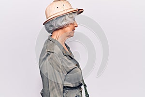 Senior grey-haired woman wearing explorer hat looking to side, relax profile pose with natural face with confident smile