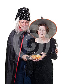 Senior Halloween couple handing out candy