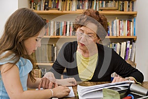 Senior halping child doing homework