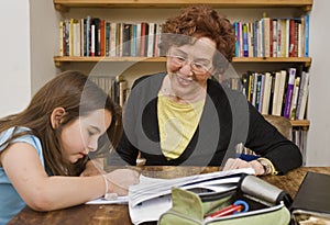 Senior halping child doing homework