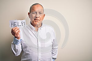 Senior handsome businessman holding paper help message over isolated white background with a happy face standing and smiling with