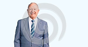 Senior handsome grey-haired man wearing elegant suit with a happy and cool smile on face