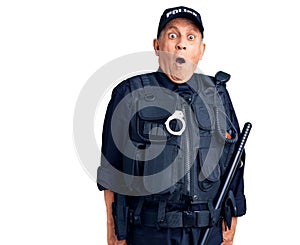Senior handsome man wearing police uniform scared and amazed with open mouth for surprise, disbelief face
