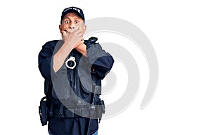 Senior handsome man wearing police uniform shocked covering mouth with hands for mistake