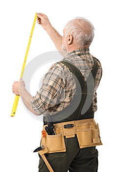 Senior handyman measuring