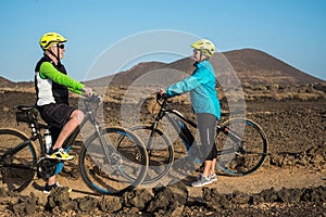 Senior happy couple in outdoor excursion with electric bicycles, electrobike. Active retired elderly people wellness concept