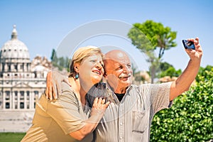 Senior happy couple taking a selfie photo in Rome