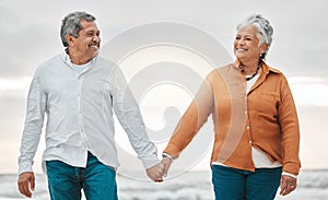 Senior happy couple, walk beach and holding hands for smile, bond and care with romance, love and vacation. Elderly man