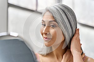 Senior happy middle aged mature asian woman closeup portrait. Skin care advertising.