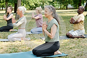 Senior healthy woman meditating outdoors
