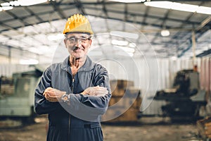 Senior high skill professional engineer male worker in heavy industry factory standing confident. portrait healthy elderly smart