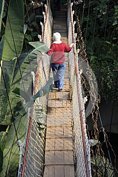 Senior hiker on a hanging bridge