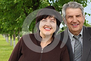 Senior and his daughter standing and smiling